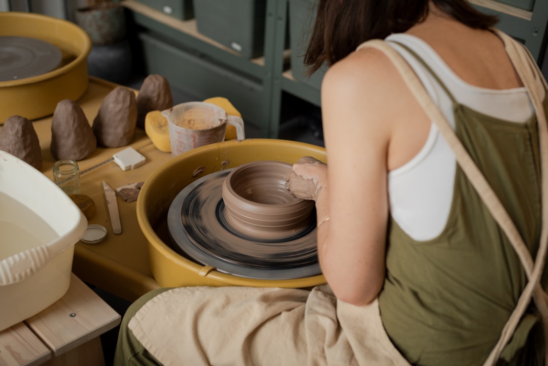 Hands shaping clay in a studio, representing craft and meaningful work.